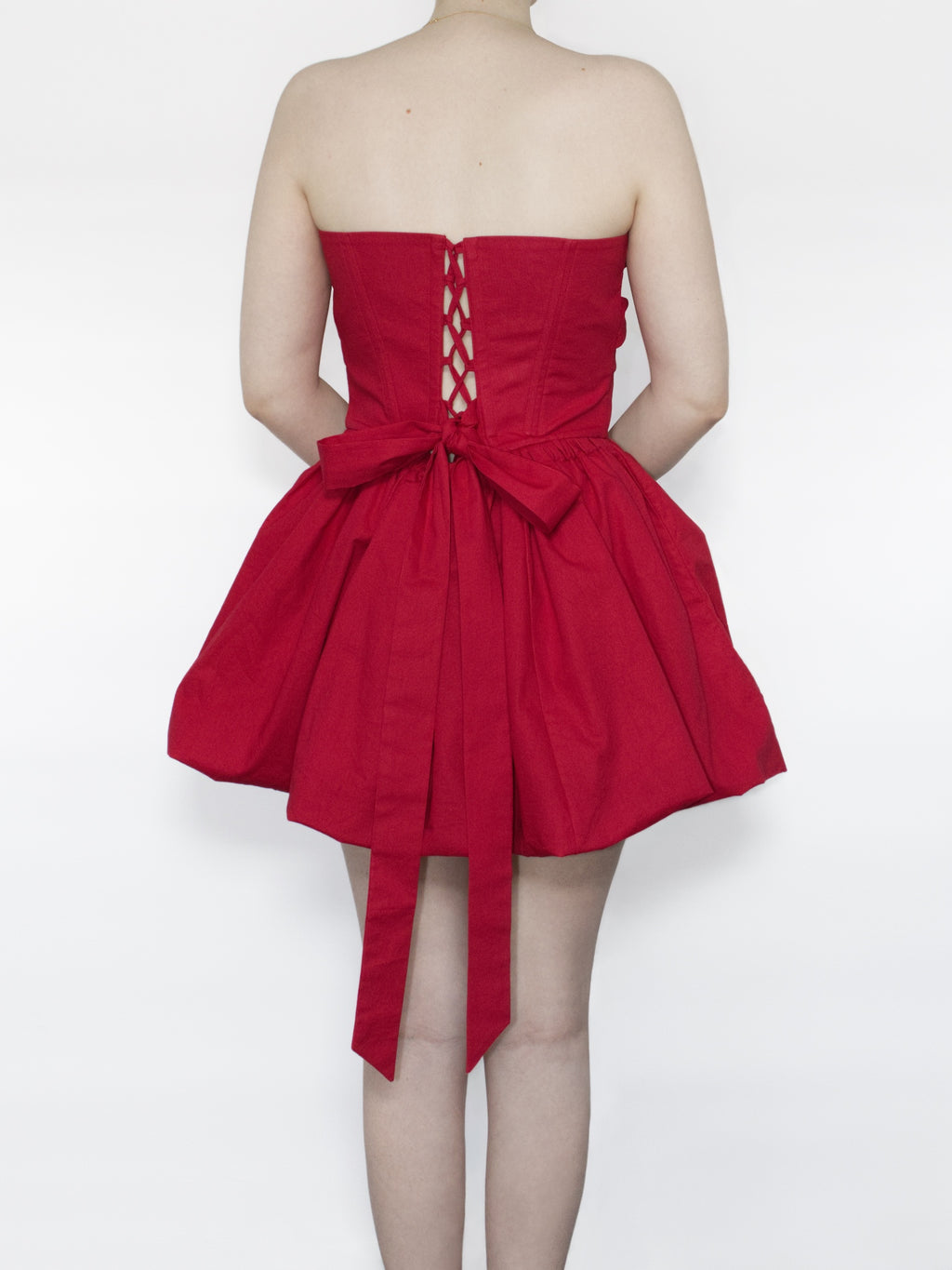 Back view showing the lace-up closure and large bow tied up.