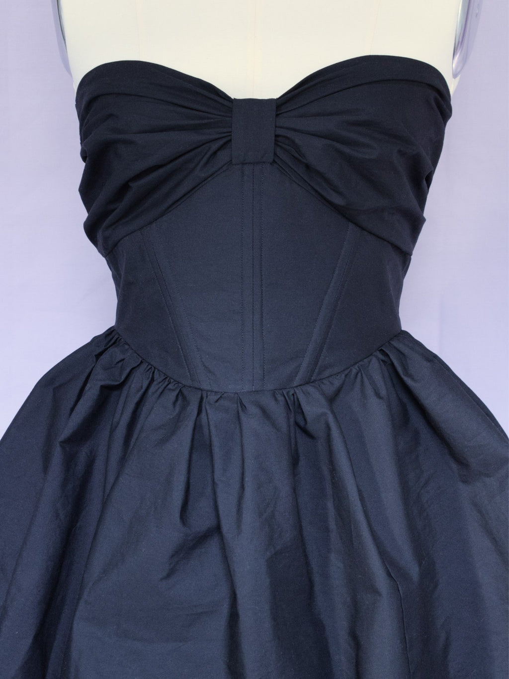 Detail view showing the gathered bow across the bust and boning channels in the bodice.