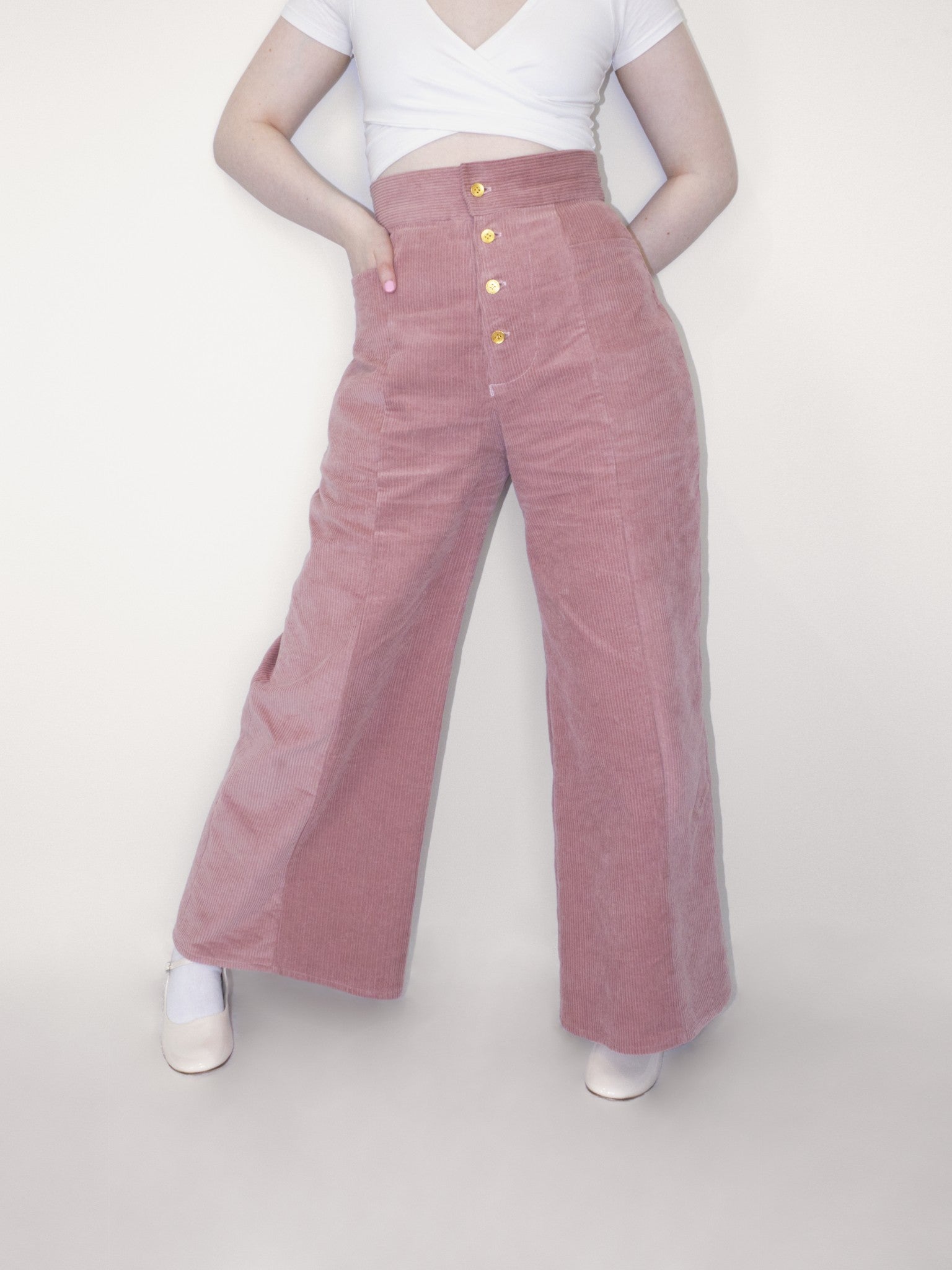 Front view with the model placing her hand in the front pocket.