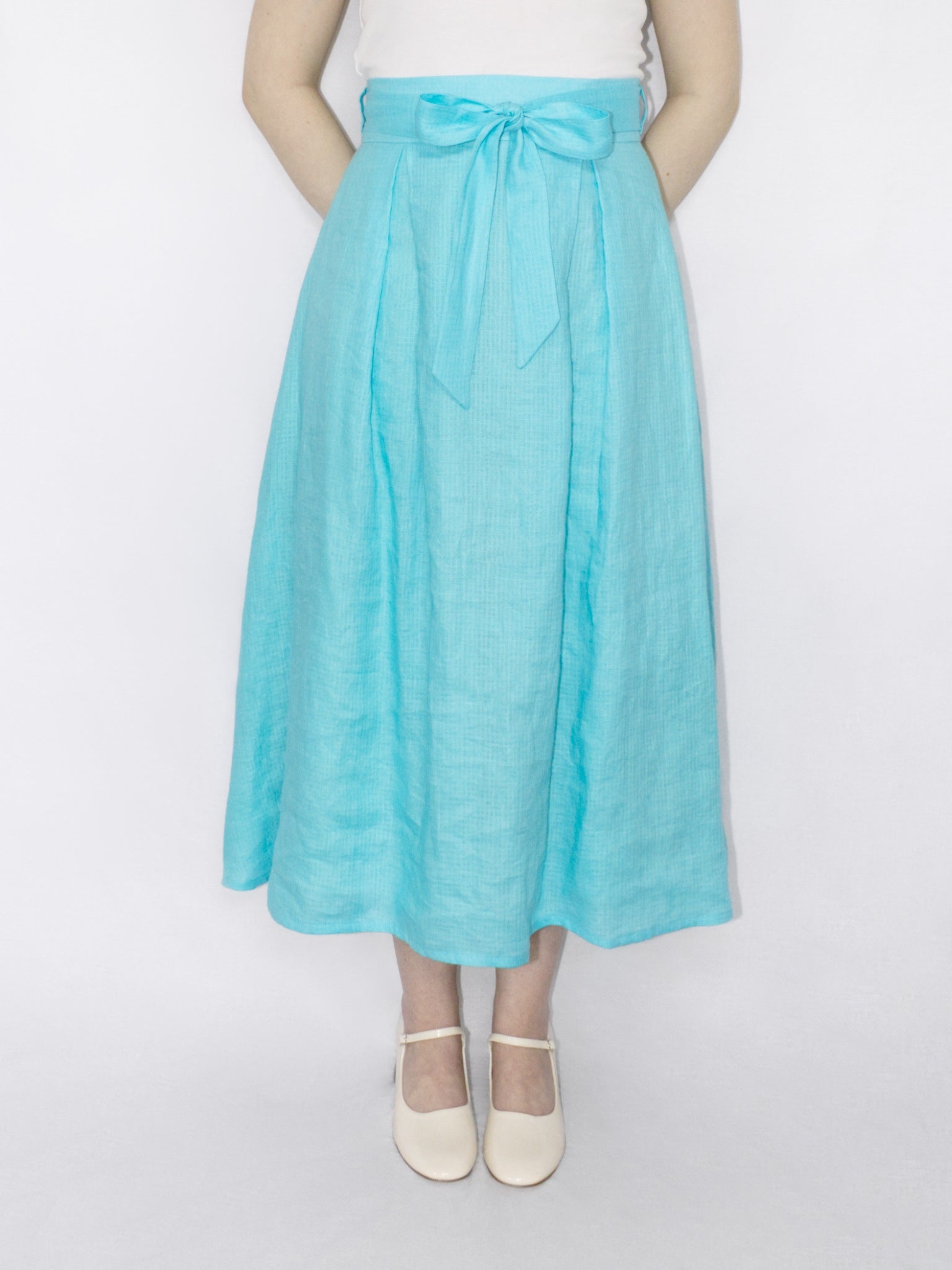 The skirt worn by itself with a matching belt tied into a bow at the centre front of the waistband.